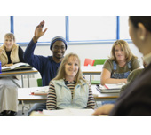 Picture of a man raising his hand in a classroom